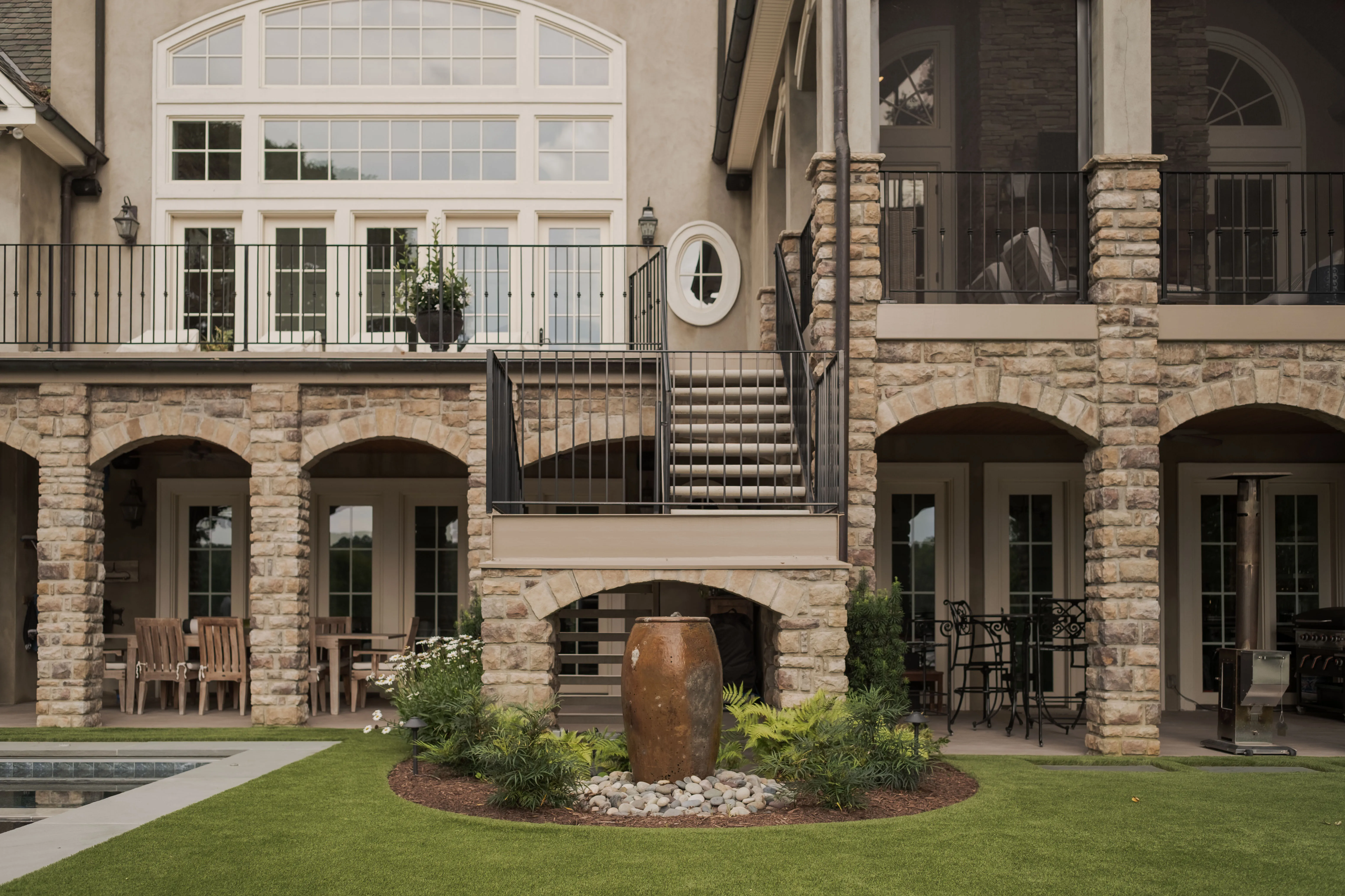 Freshly planted front yard landscape with hydrangeas, evergreen shrubs, and clean mulch beds in front of a modern Southern-style home.