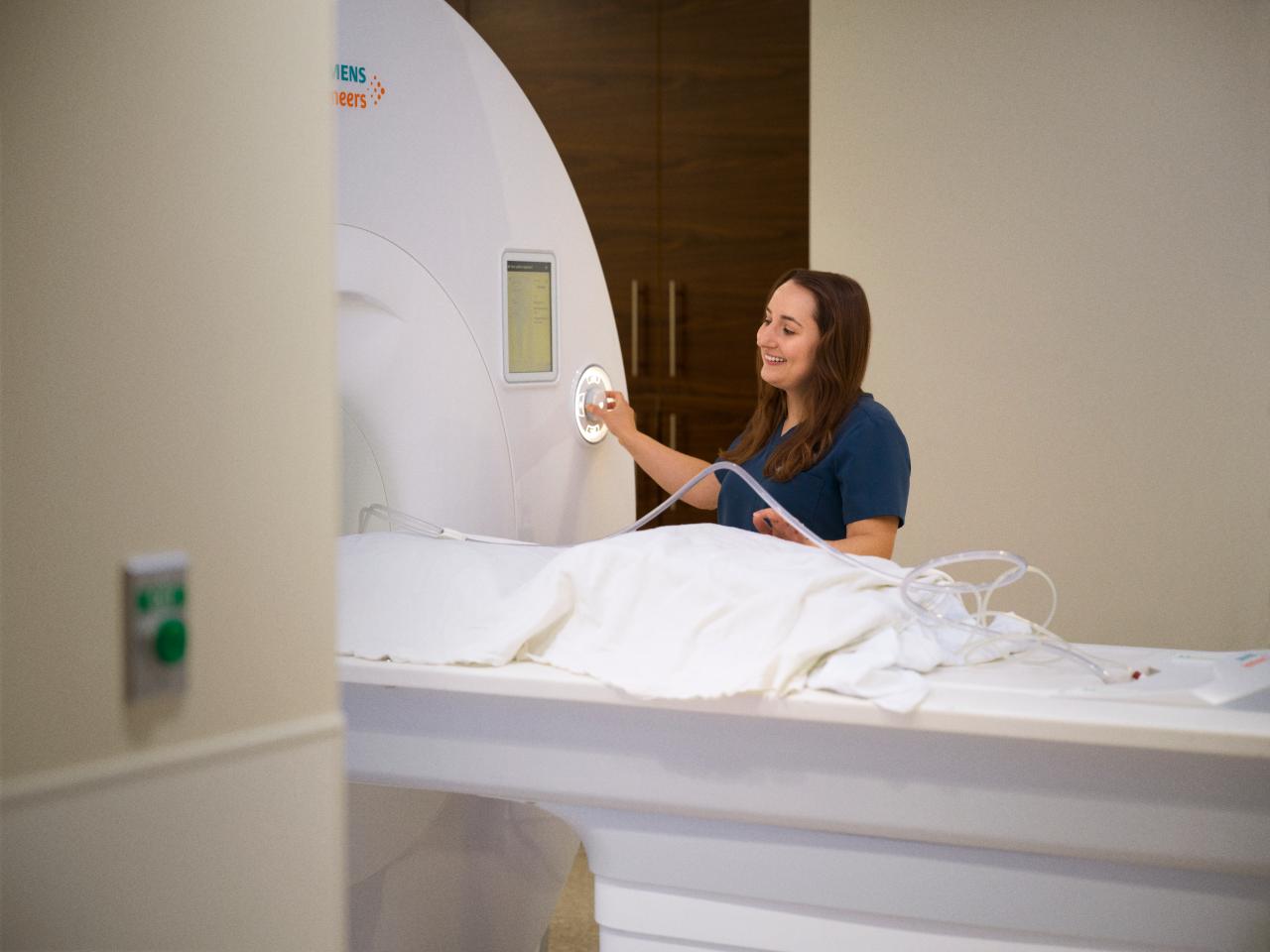 Student next to MRI Machine