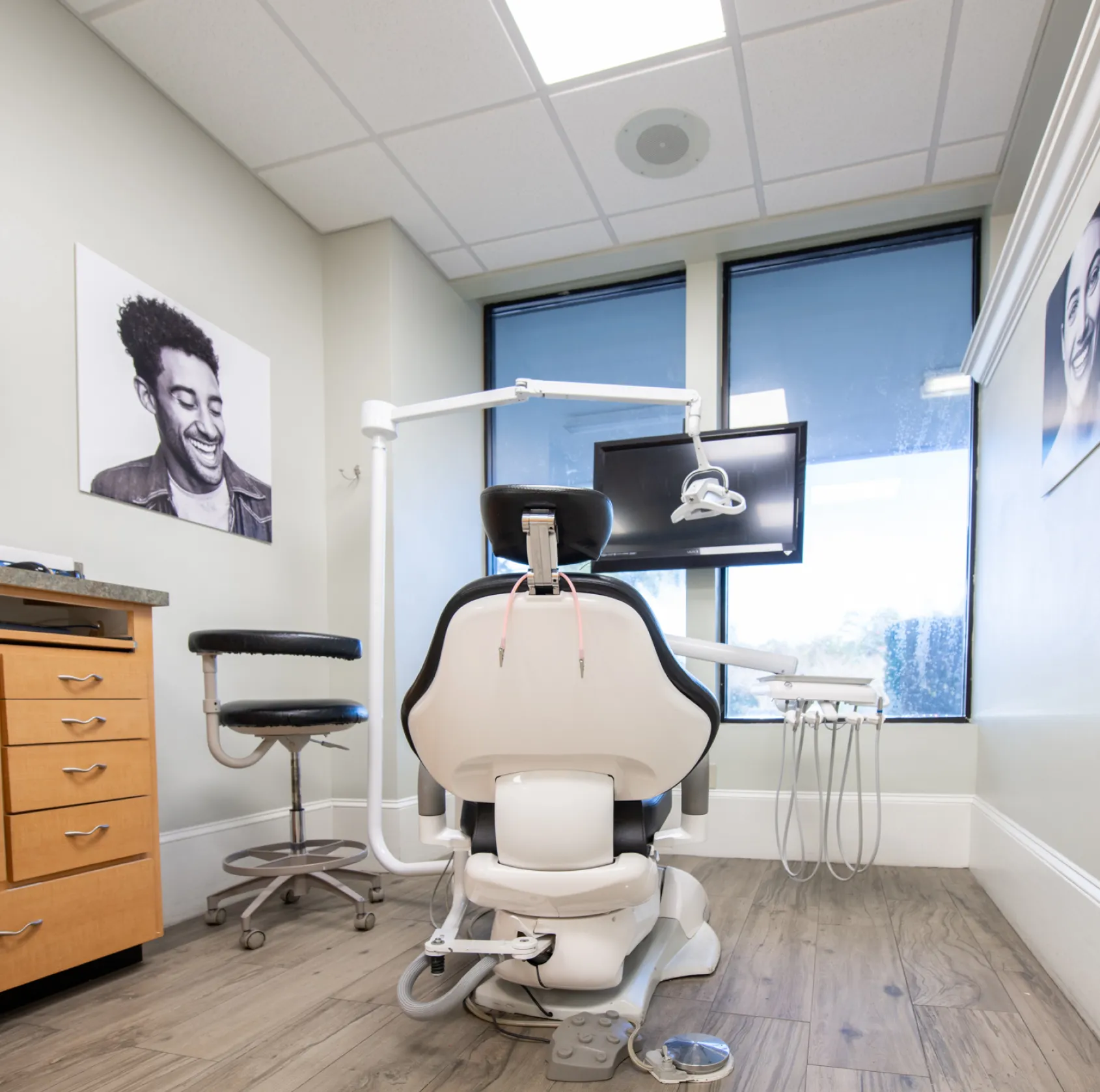 Elevator interior with a smiling woman’s photo and the words "Elevated Dental Care" on the wall.