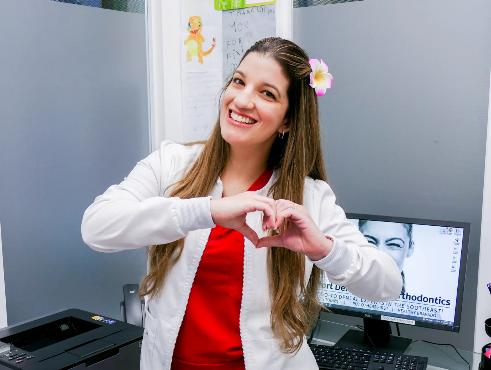 A waiting room with chairs and wall-mounted images of people in a hallway setting.