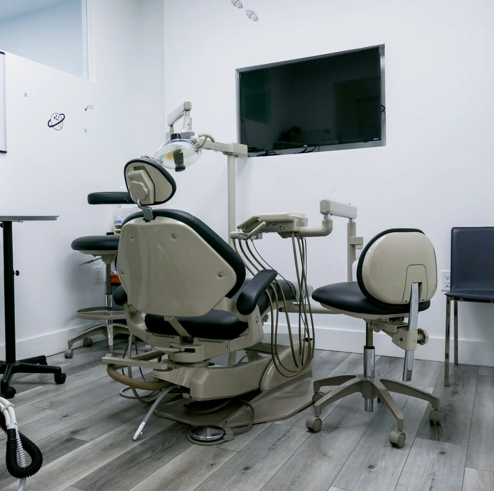 A smiling woman with sunglasses on her head wears a denim jacket.