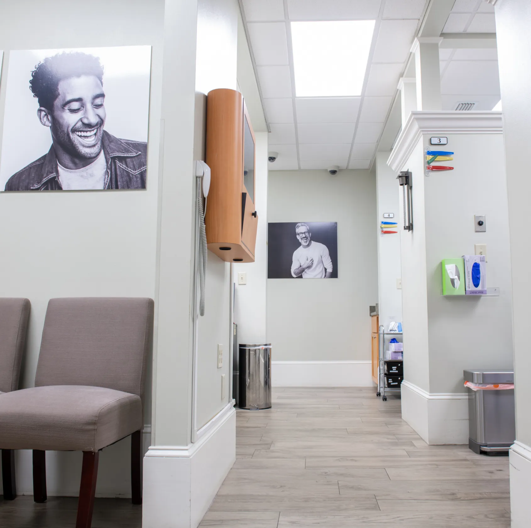 A woman winks and smiles while holding a clear dental aligner in her hand.