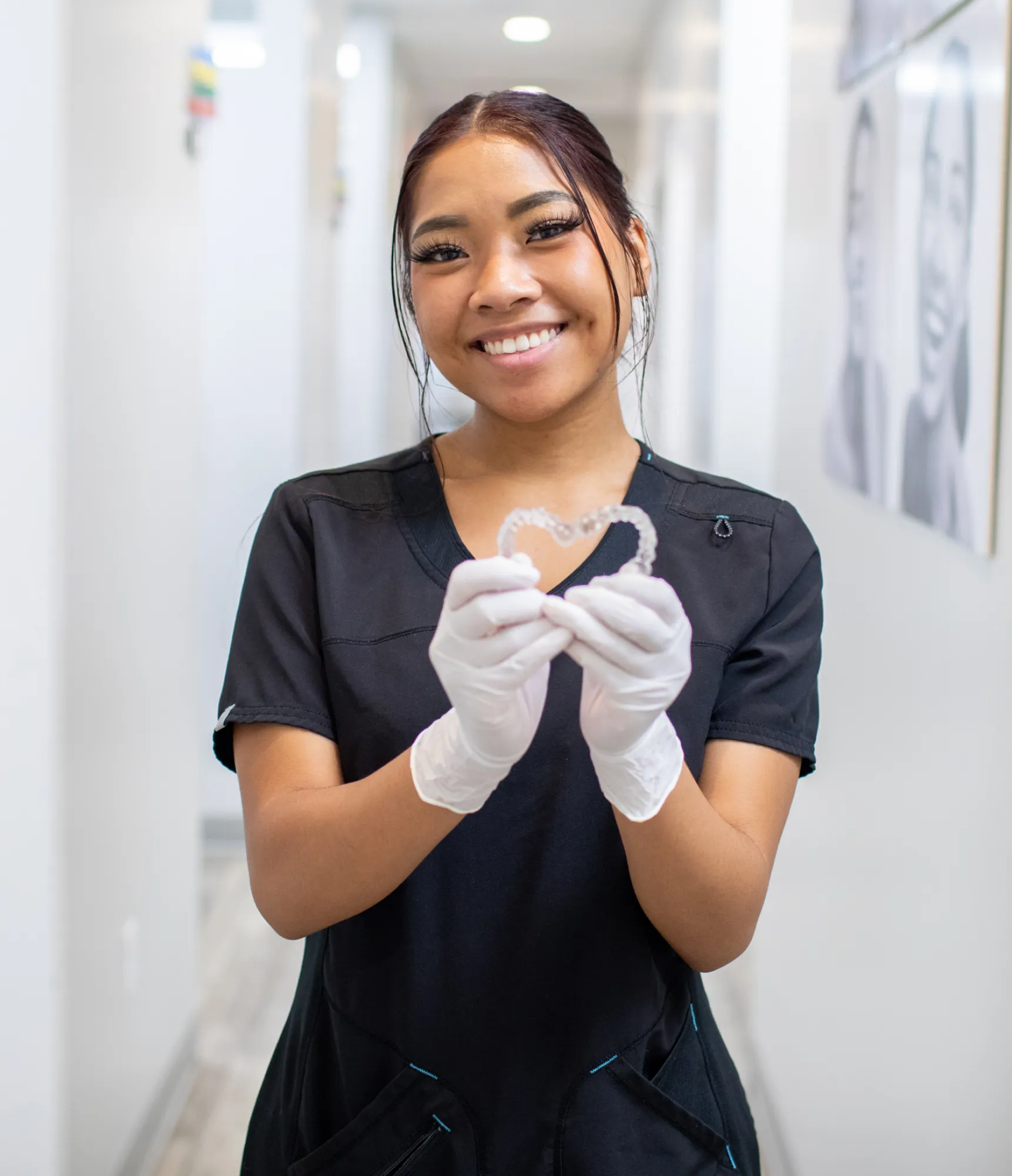 A modern, well-lit waiting room with chairs, a reception desk, and colorful hanging decorations.
