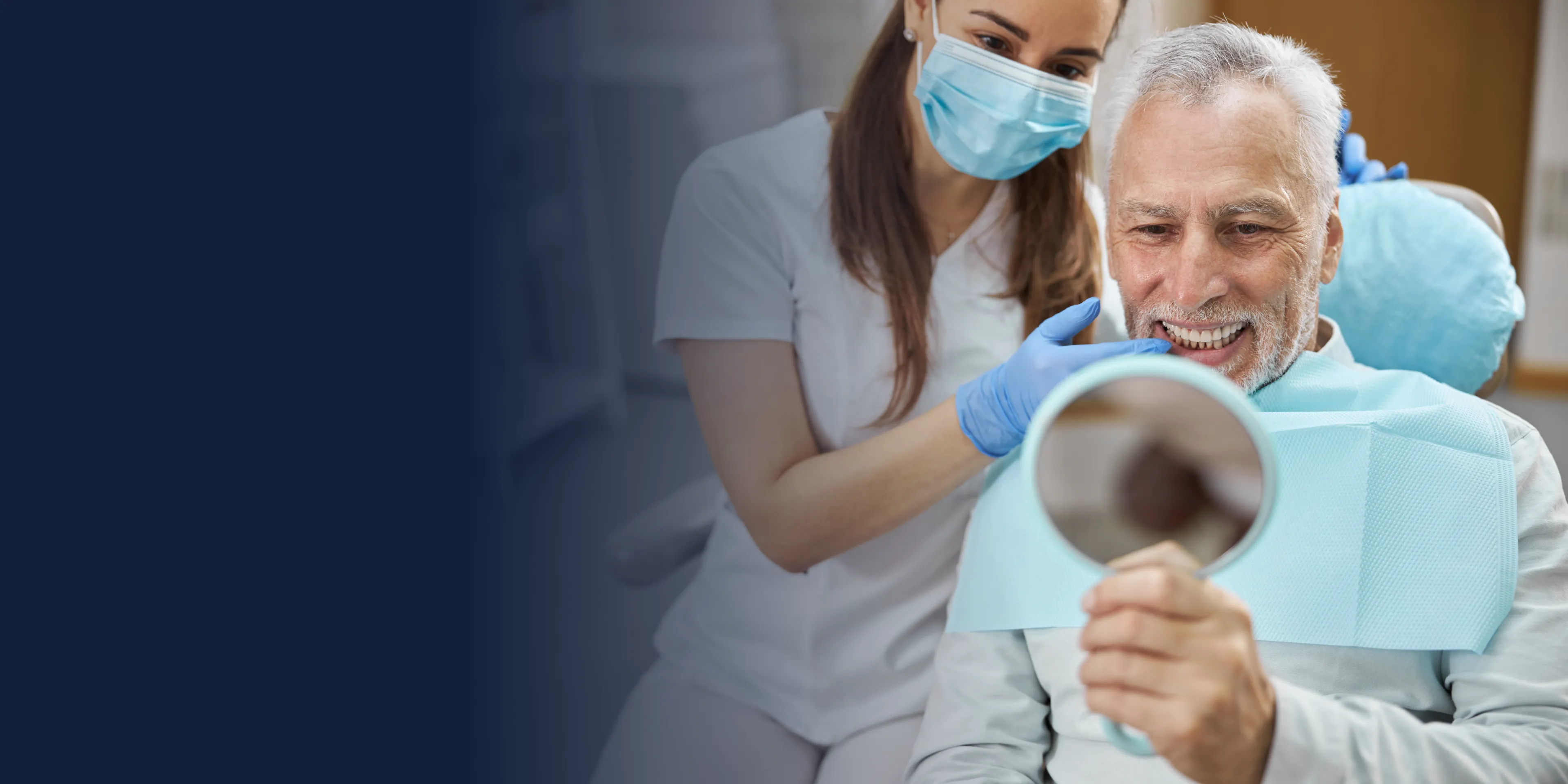 Two women happily high-fiving each other in an office near a computer.