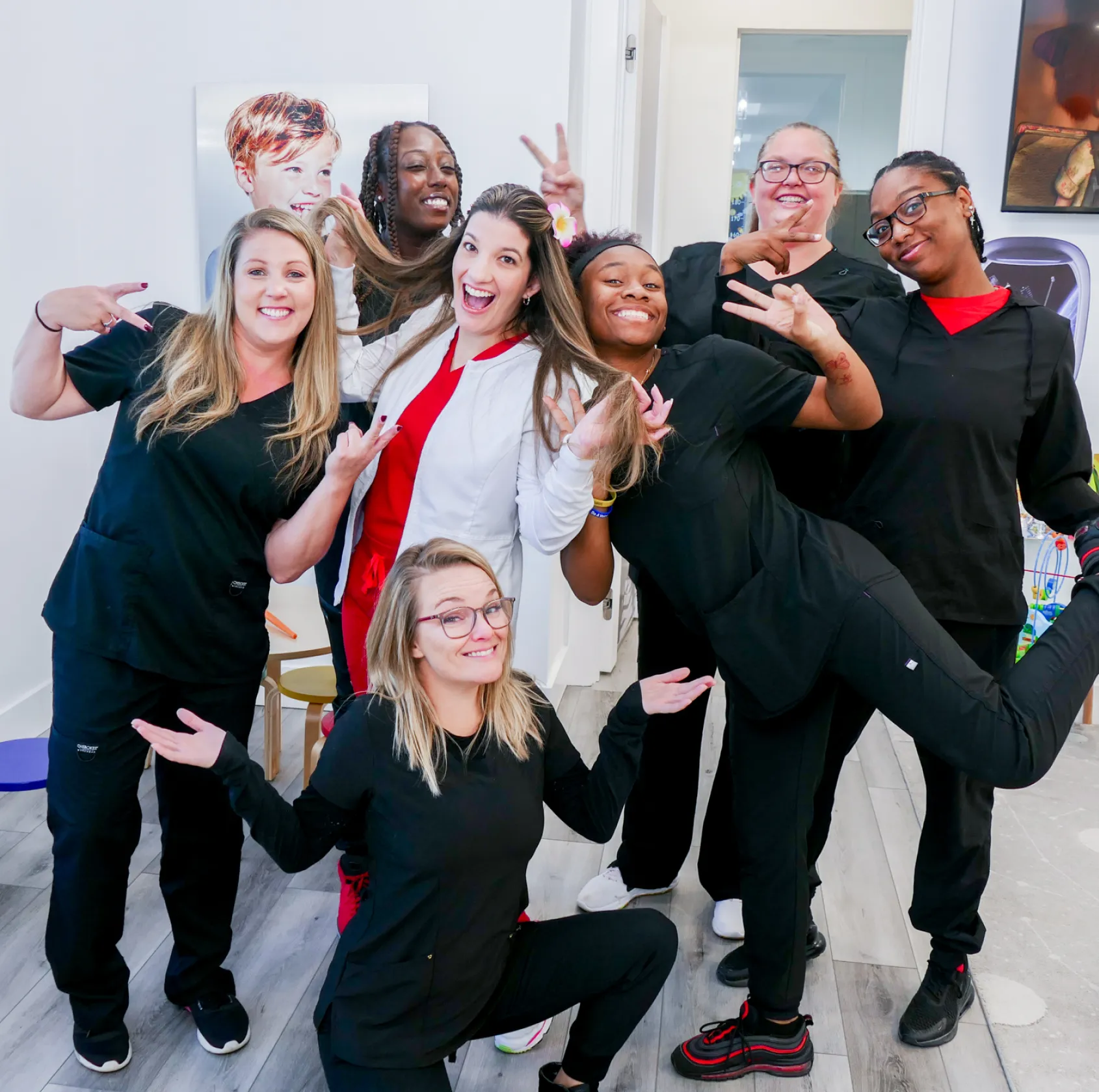 Two children play with a colorful bead maze toy on a small table.