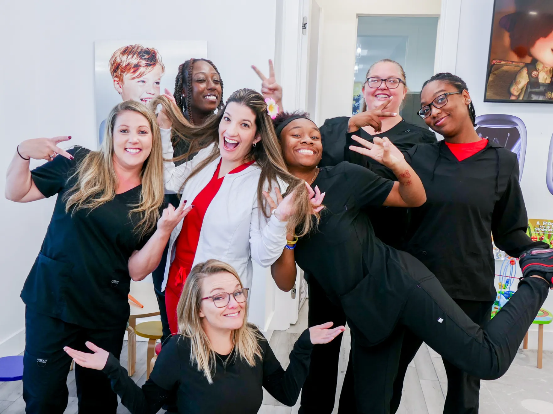 Dental office with an empty examination chair, dental tools, and monitors on the walls.
