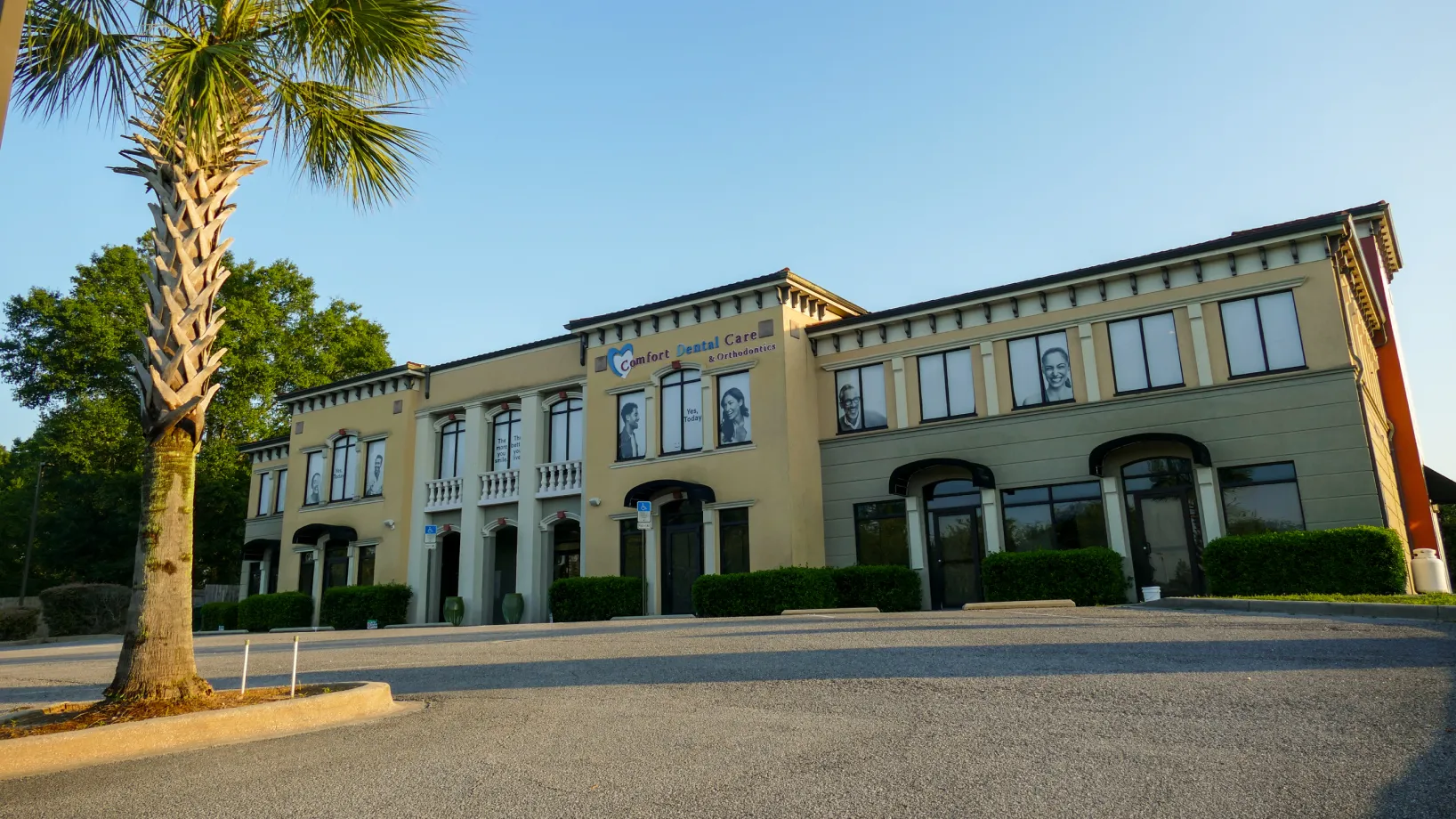 A dental chair with equipment is positioned next to a window in a bright room.