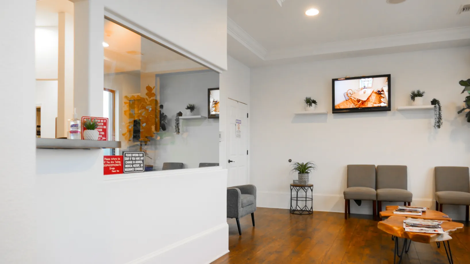 A waiting area with a reception desk, chairs, and colorful ceiling decorations resembling planets.
