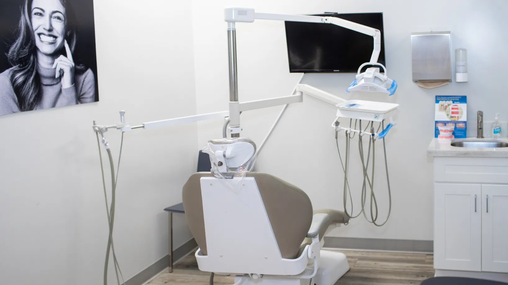 A dental clinic exterior with a sign that reads "Comfort Dental Care" next to a parking space.