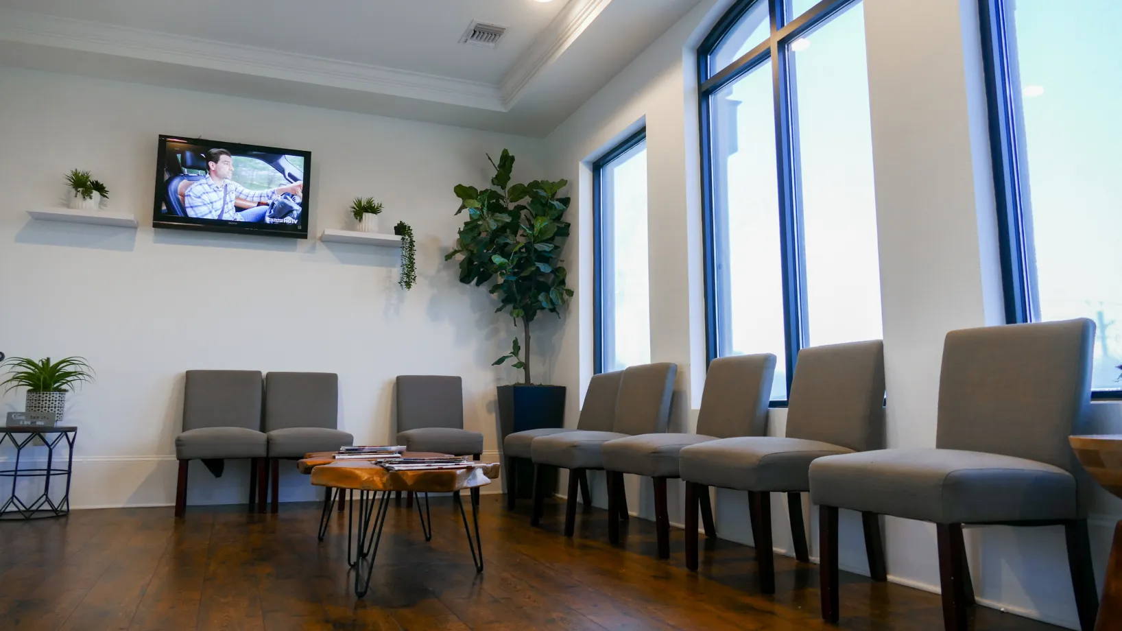 Exterior of Comfort Dental Care & Orthodontics building with large smiling faces on windows.