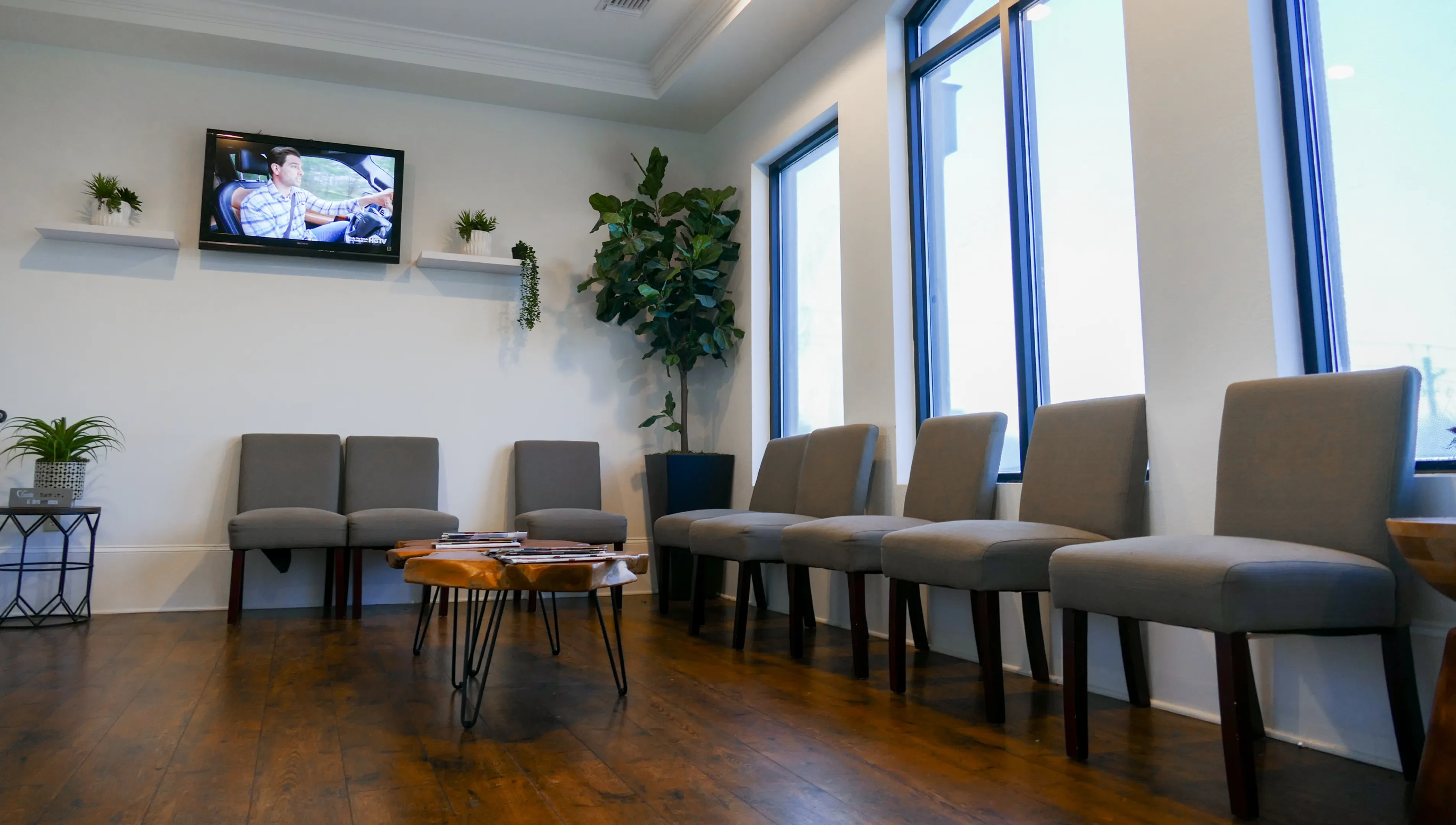 Exterior of a dental care office with large portraits of smiling individuals on the windows.
