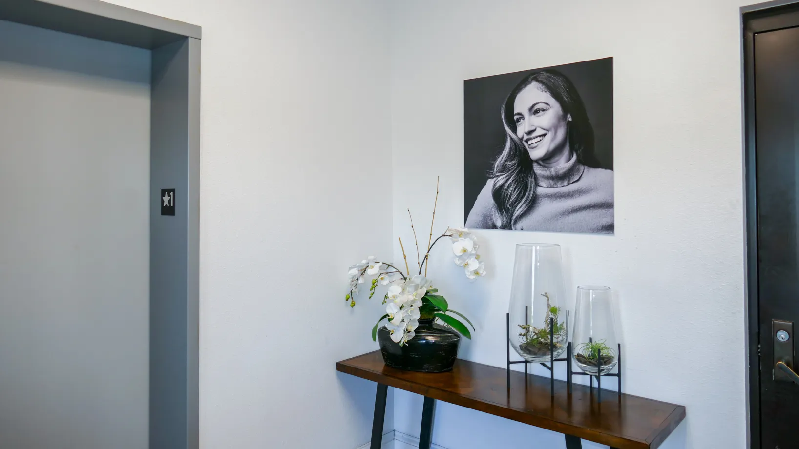 Elevator interior with a poster showing a smiling woman and text "Elevated Dental Care."