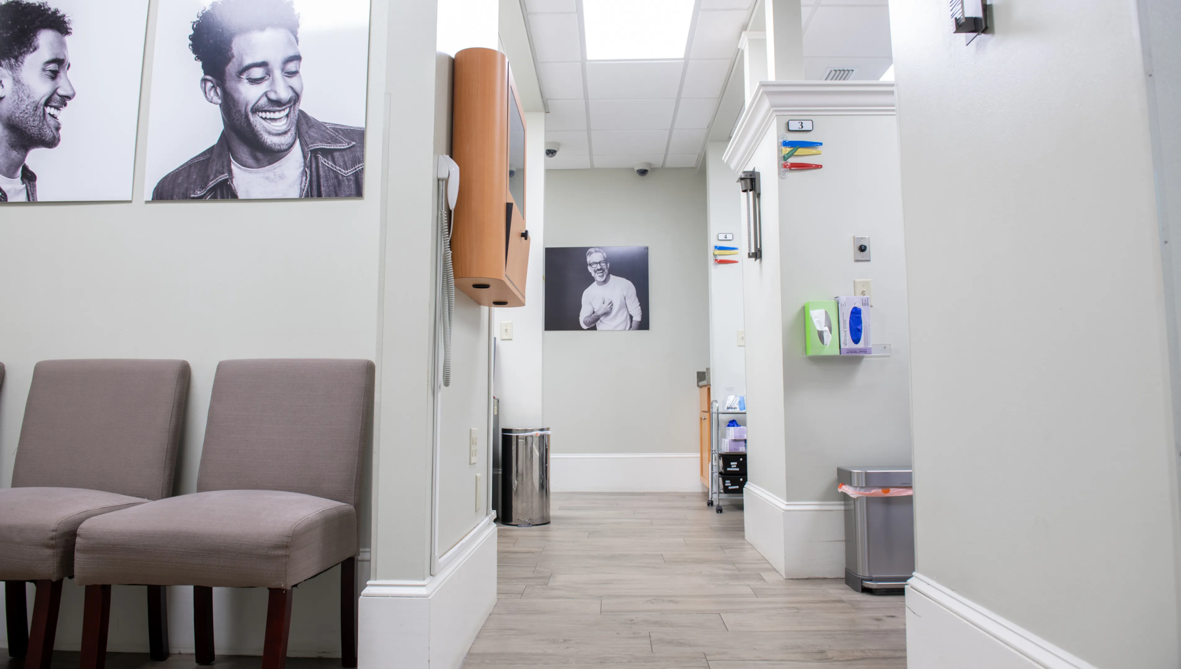 A veterinary clinic lab room with wooden cabinets, medical equipment, and shelves stocked with supplies.