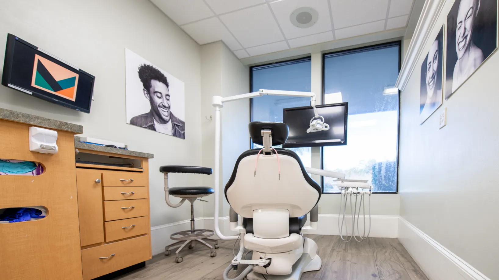 Dental office storage area with wooden cabinets, medical equipment, and shelves stocked with supplies.