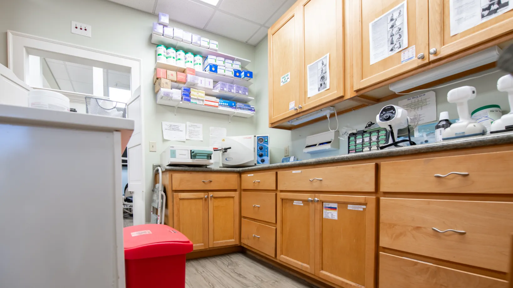 Entrance door of a dental office with large photos of smiling people on the windows.