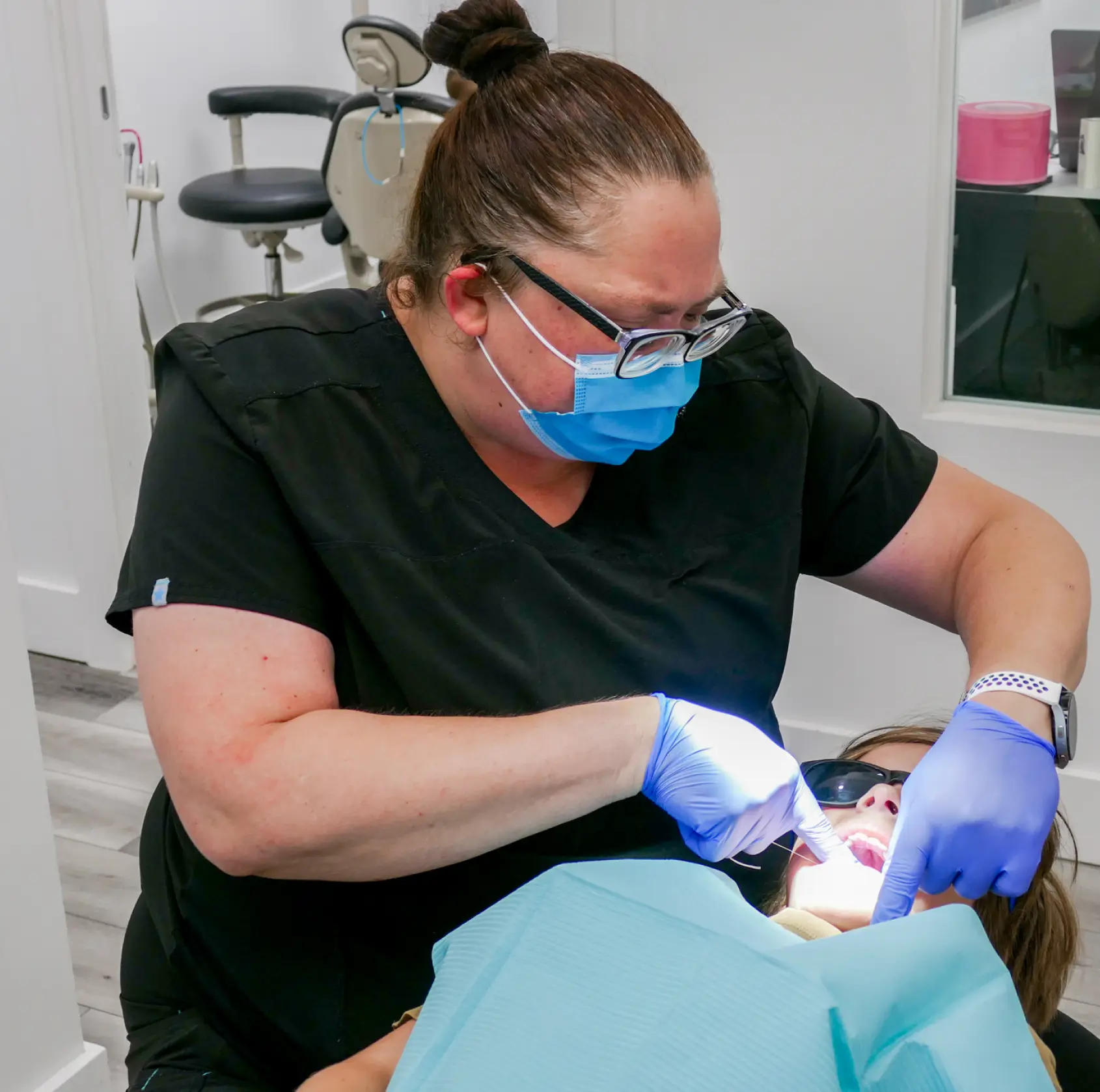 Dentist examining a patient's teeth in a dental clinic.