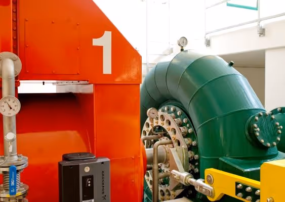 Industrial machinery with a large green pipe and an orange component marked with the number 1.
