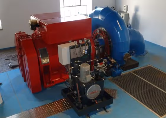 Industrial red and blue machinery equipment installed on a blue floor inside a clean facility room.