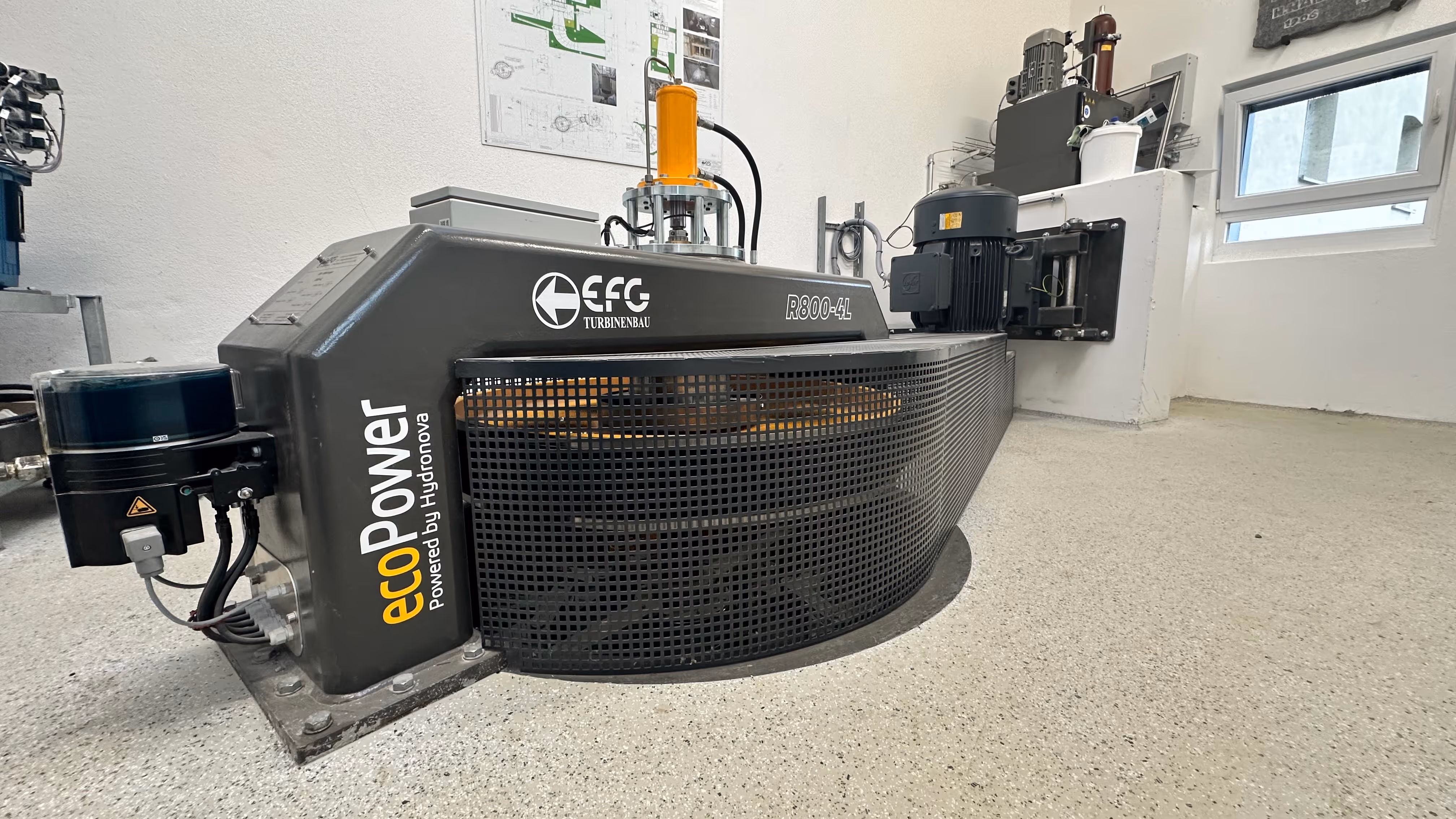 EcoPower R800-4L hydropower turbine unit with protective mesh and motor in a clean industrial room.