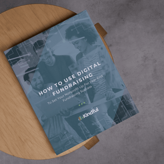Booklet titled 'How to Use Digital Fundraising' on a wooden chair with a concrete floor background.