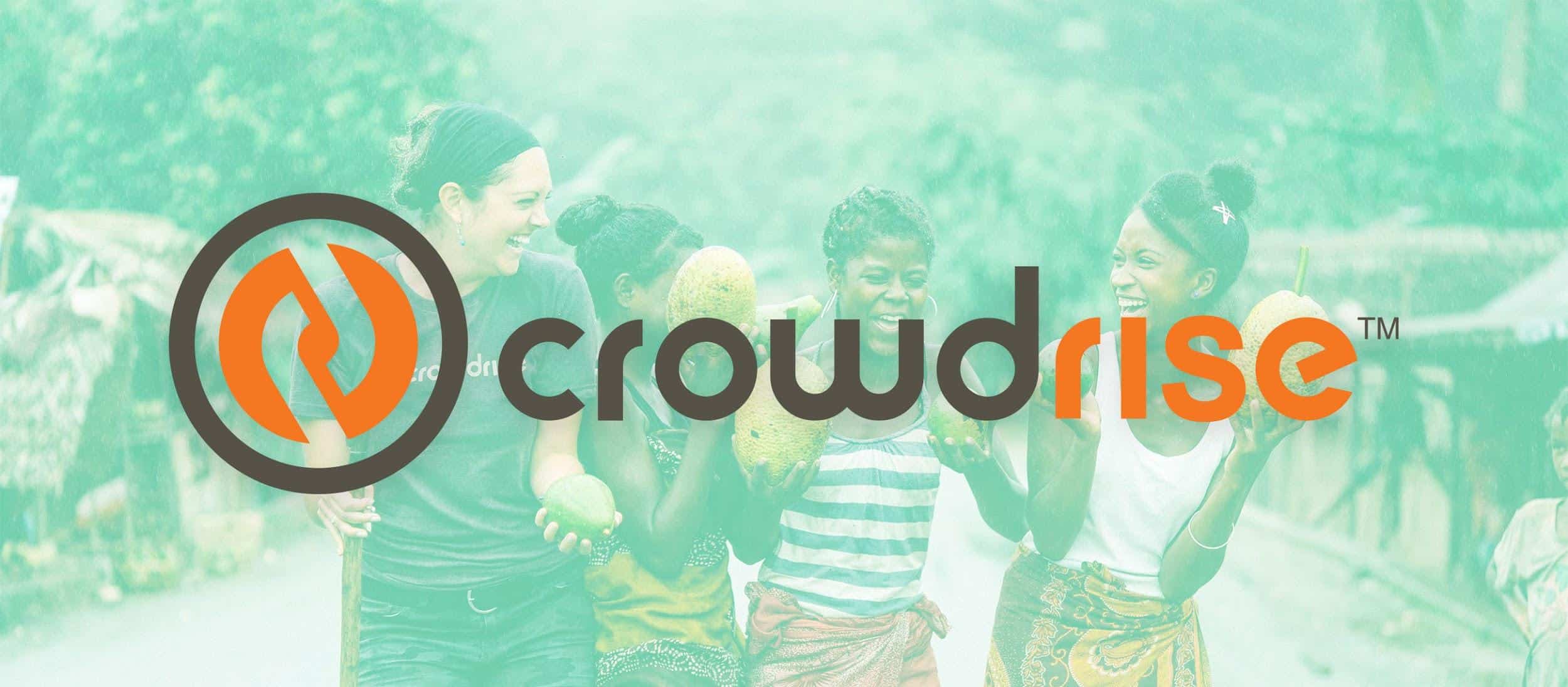 Four women smiling and holding tropical fruits outdoors with Crowdrise logo overlay.