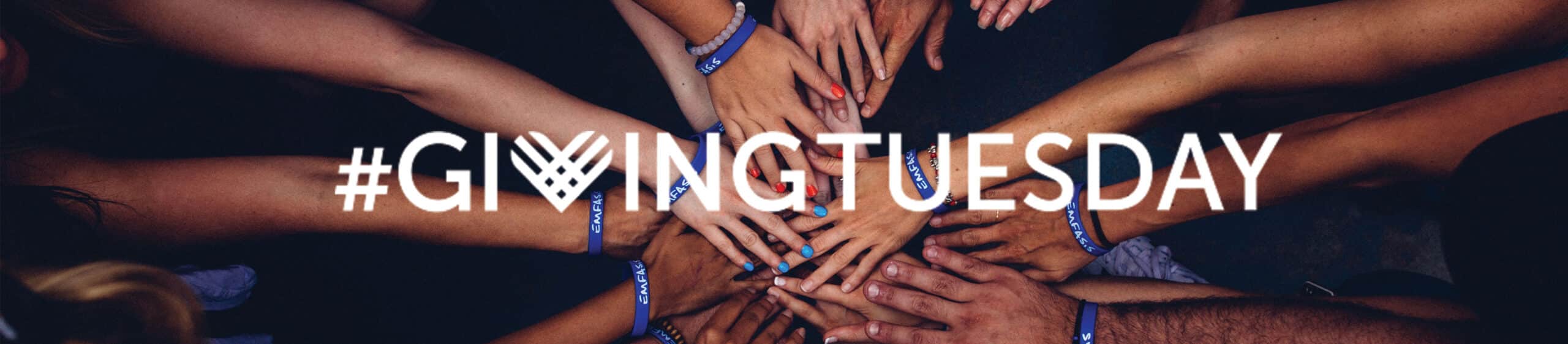 Multiple diverse hands stacked together wearing blue wristbands under #GivingTuesday text.