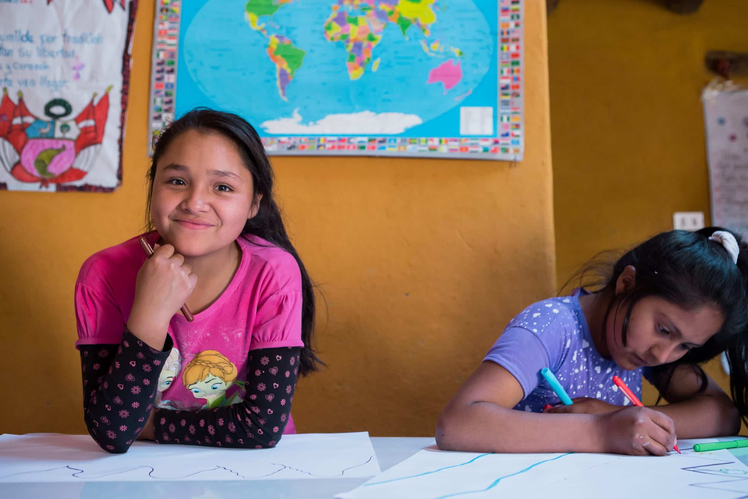 shes the first impact image showing two girls in classroom