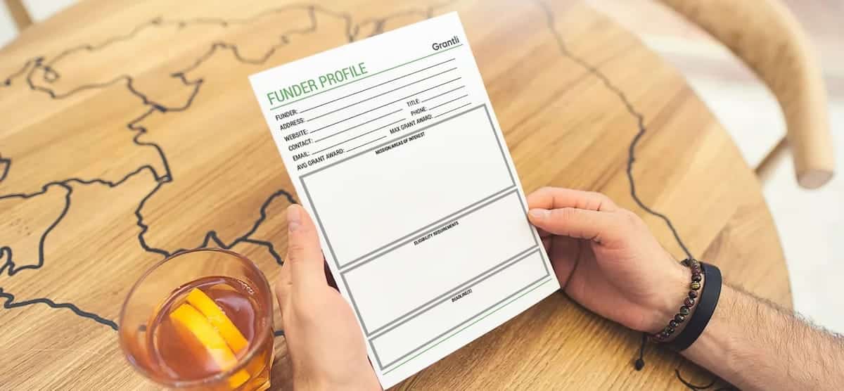 Person holding a Funding Profile worksheet to help get funding for nonprofit