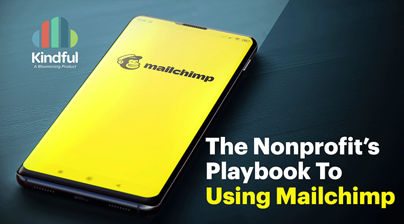 Smartphone on dark surface showing Mailchimp app with text about nonprofit playbook using Mailchimp.