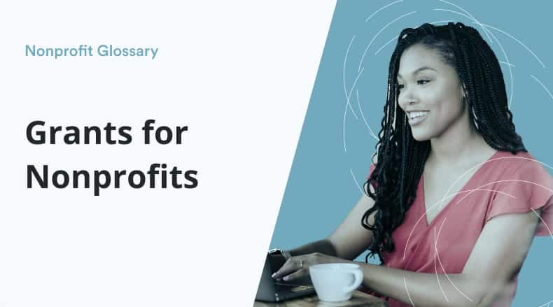 Smiling woman with braids typing on a laptop with a coffee cup, text reads Grants for Nonprofits.