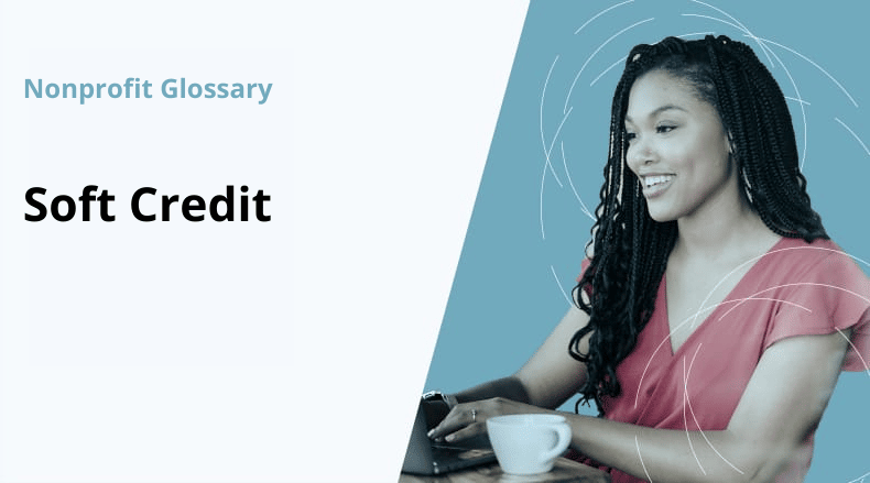 Smiling woman with braided hair using laptop with a coffee cup, labeled Nonprofit Glossary Soft Credit.