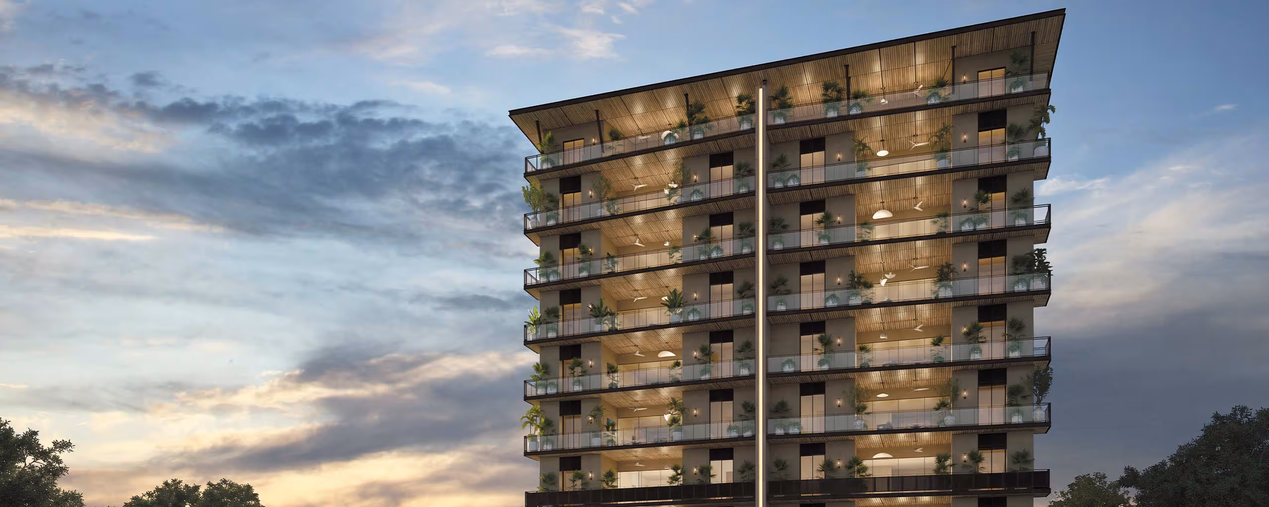 Edificio moderno de departamentos con balcones amplios y plantas, iluminado al atardecer con cielo nublado.