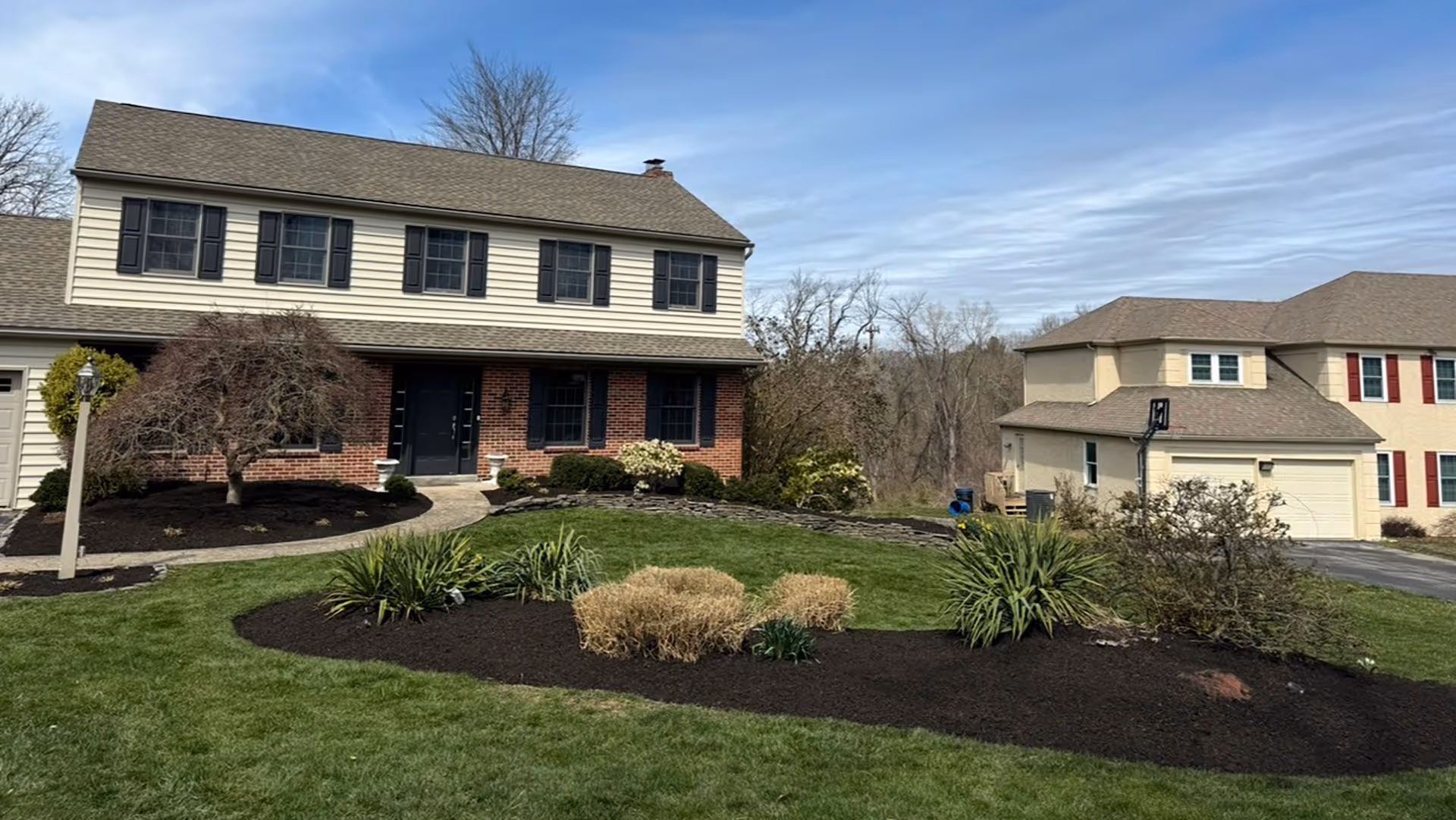 Fresh mulch and shrub planting for residential landscape upgrade