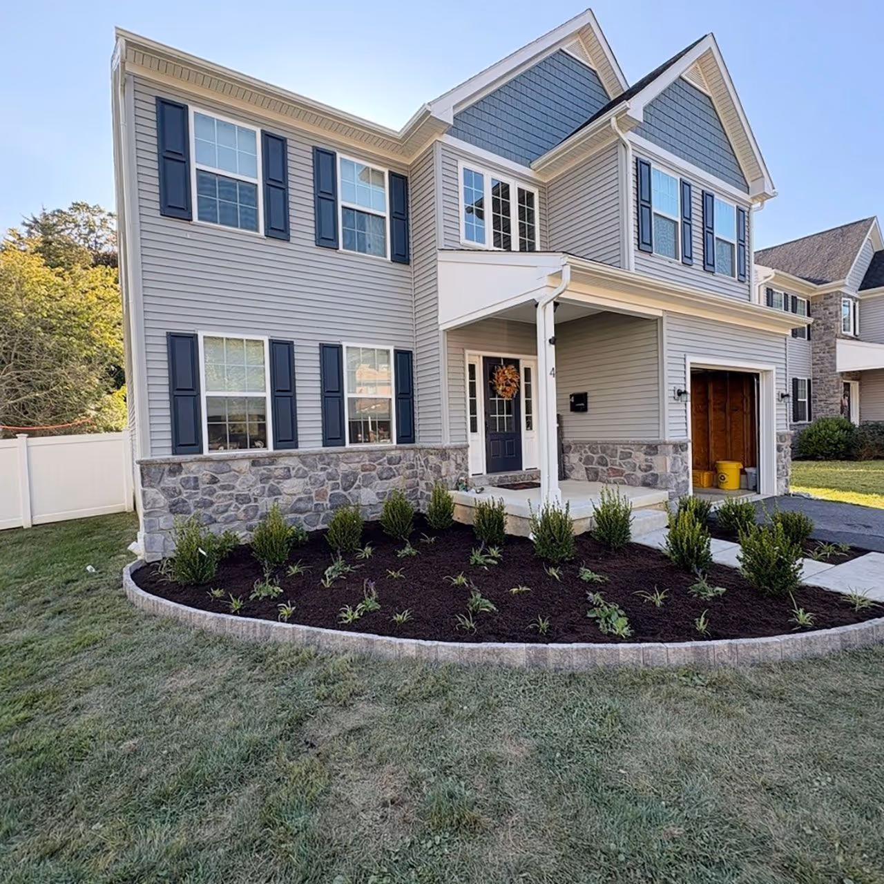 Completed landscape project showing lush lawn and planting beds