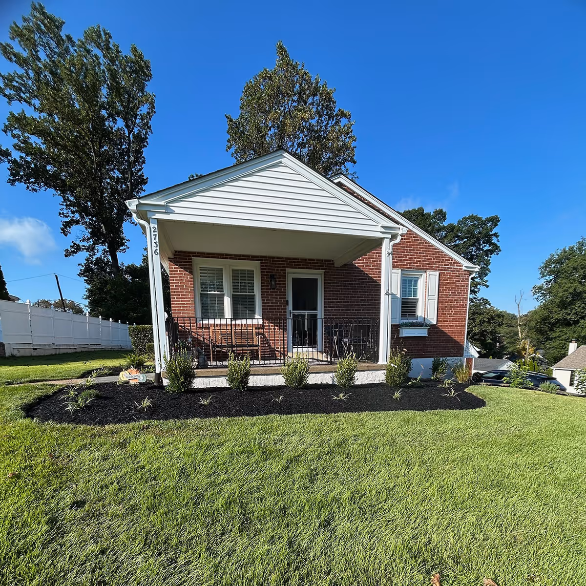 Landscape installation with plants and mulch by Santivasci Landscaping