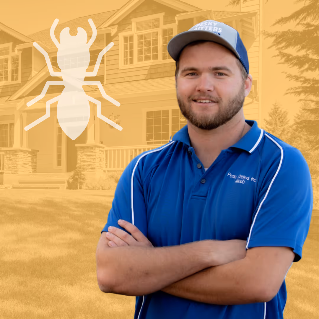 Smiling pest control technician in blue uniform with crossed arms, standing in front of a house with a translucent termite graphic overlay.