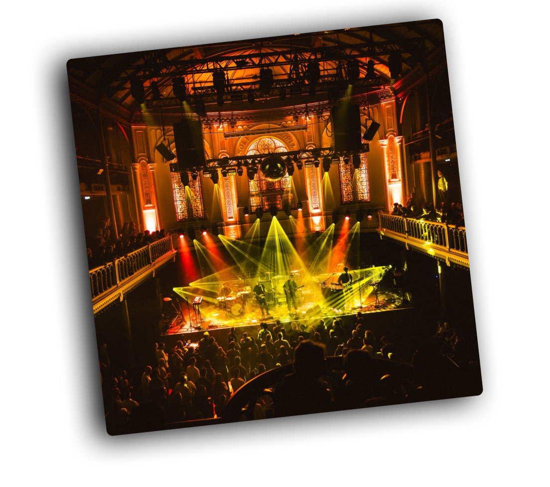 Haiver on stage with orange and yellow strong lighting