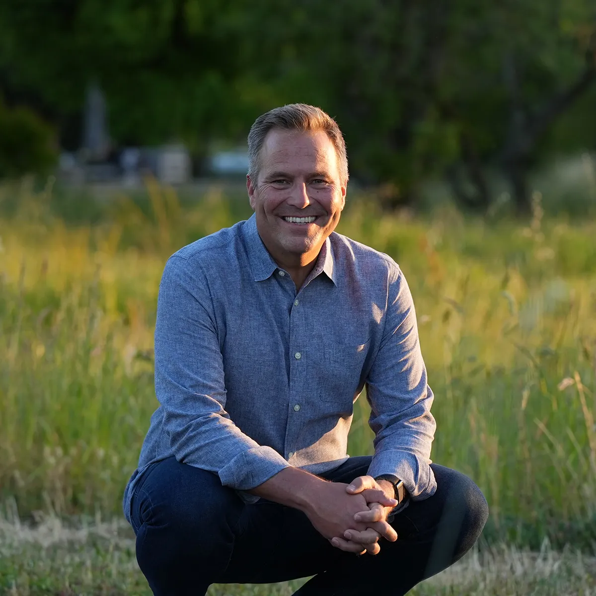 Joe Hudson, founder of Art of Accomplishment, in a sunny field