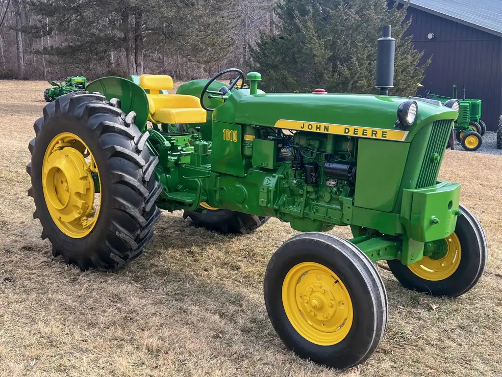 A John Deere 1010 tractor parked on grass
