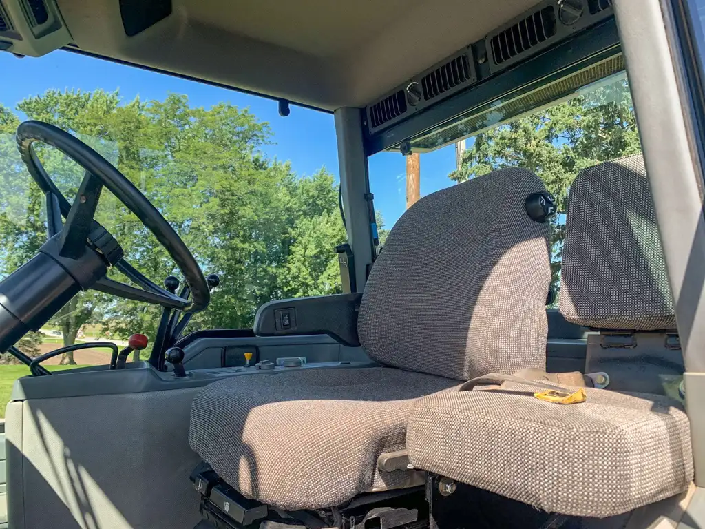 Interior of a vehicle cabin with steering wheel and two seats