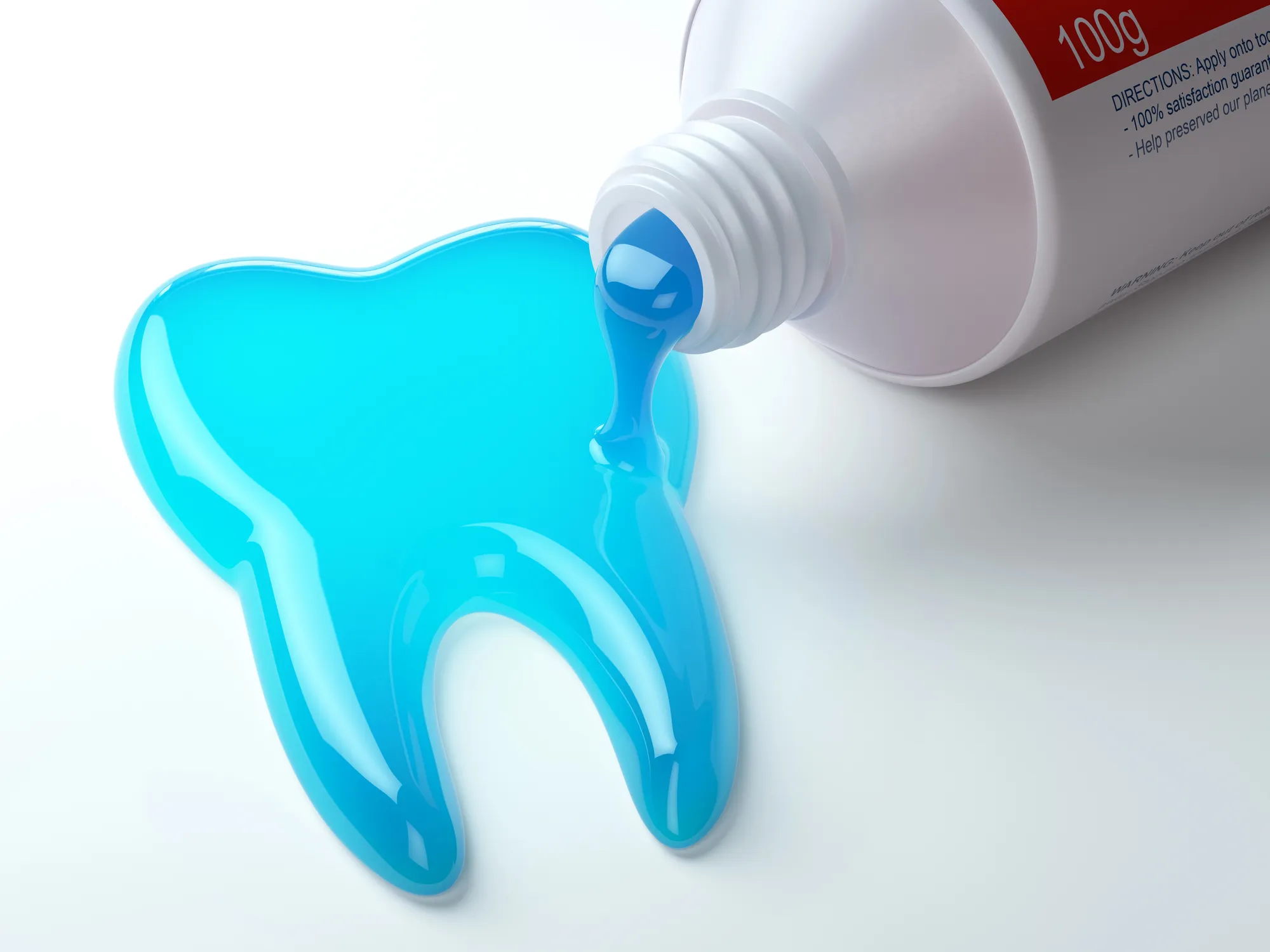 Blue gel toothpaste shaped like a tooth pouring from a white tube on a white surface.