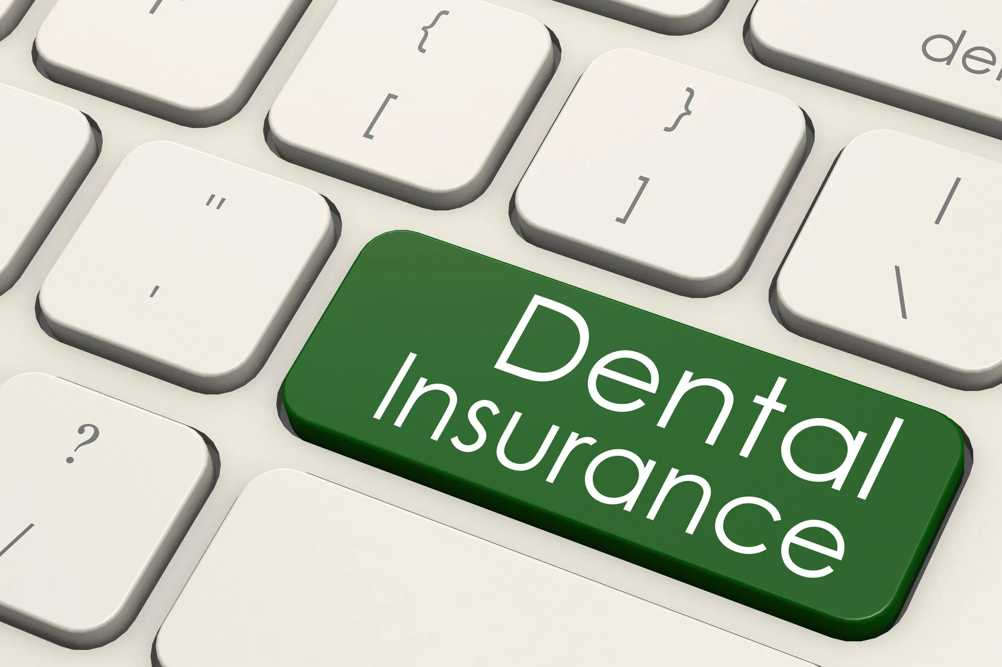 Computer keyboard with a green key labeled Dental Insurance.