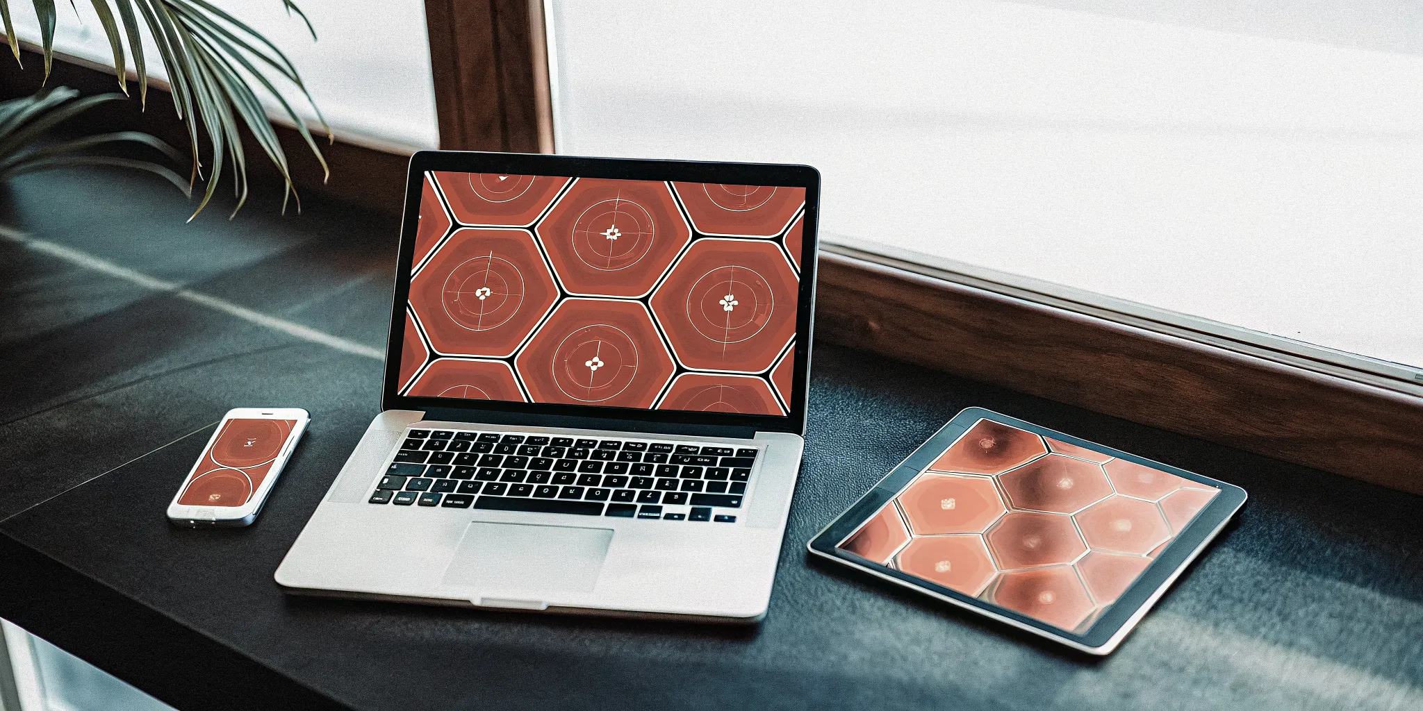 A laptop and tablet on a desk showing an online new manager development program.