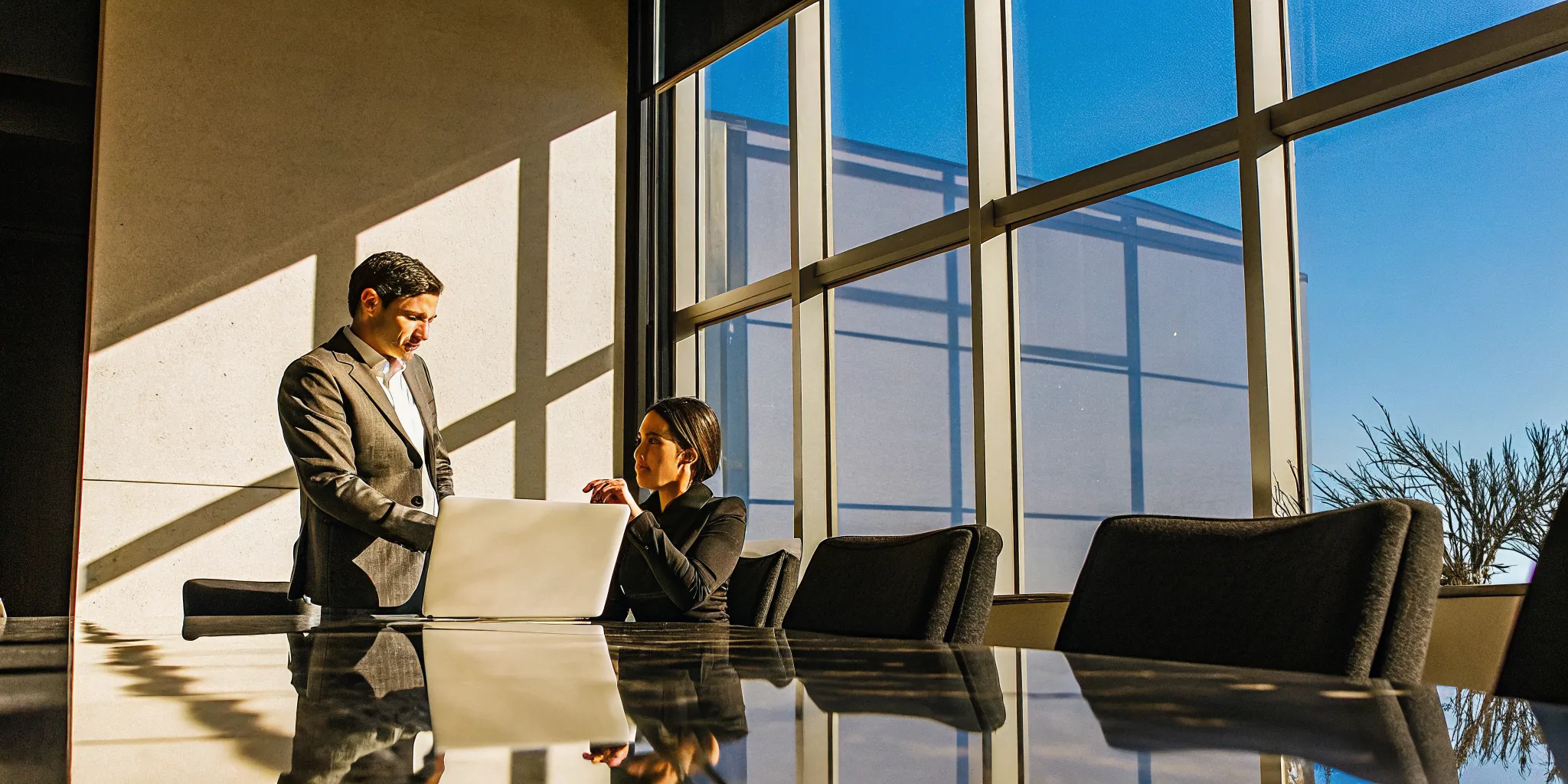 A manager coaching a team member on time management in a bright tech office
