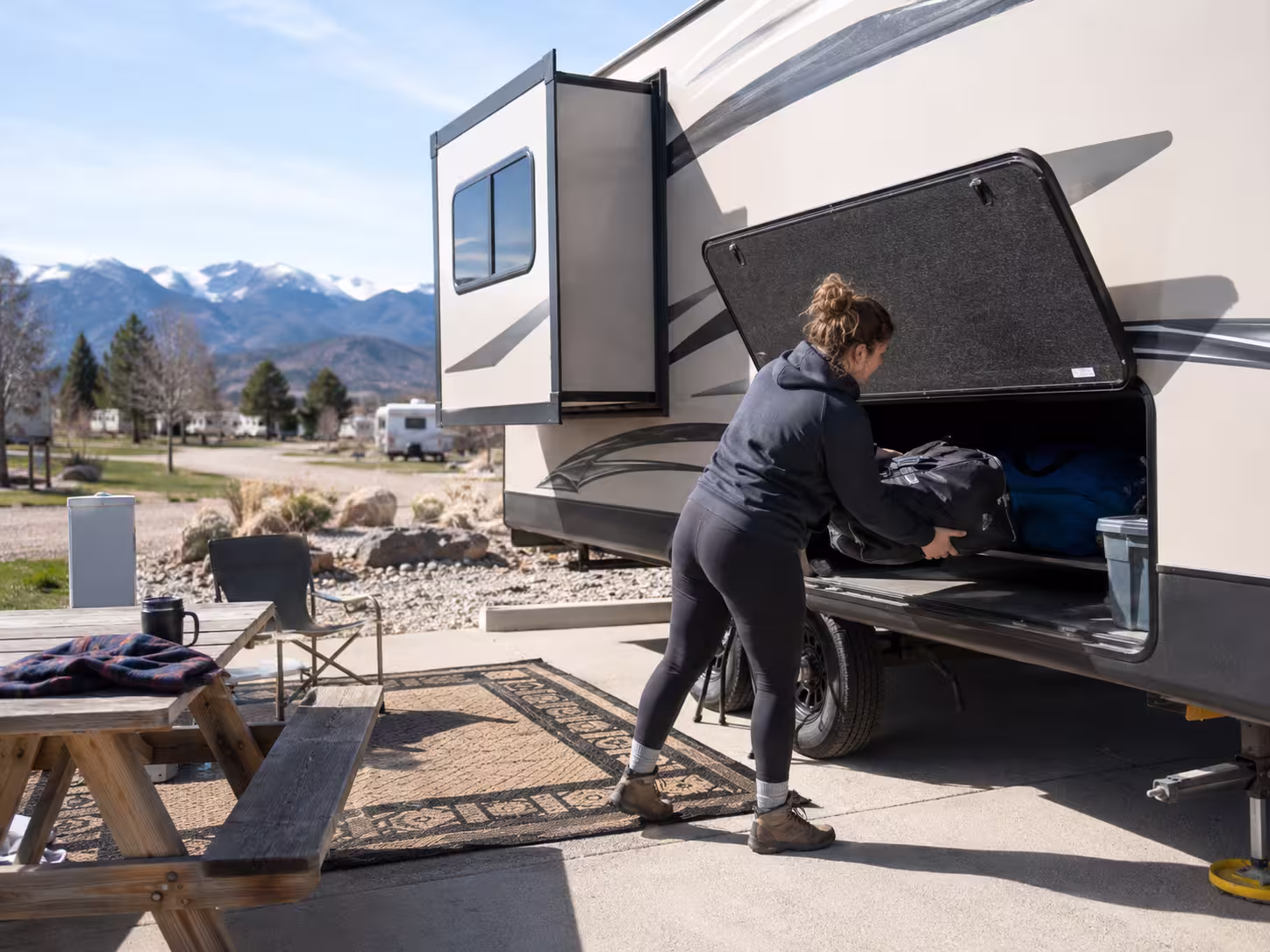 Renter loading storage bay of a long term RV rental in Denver