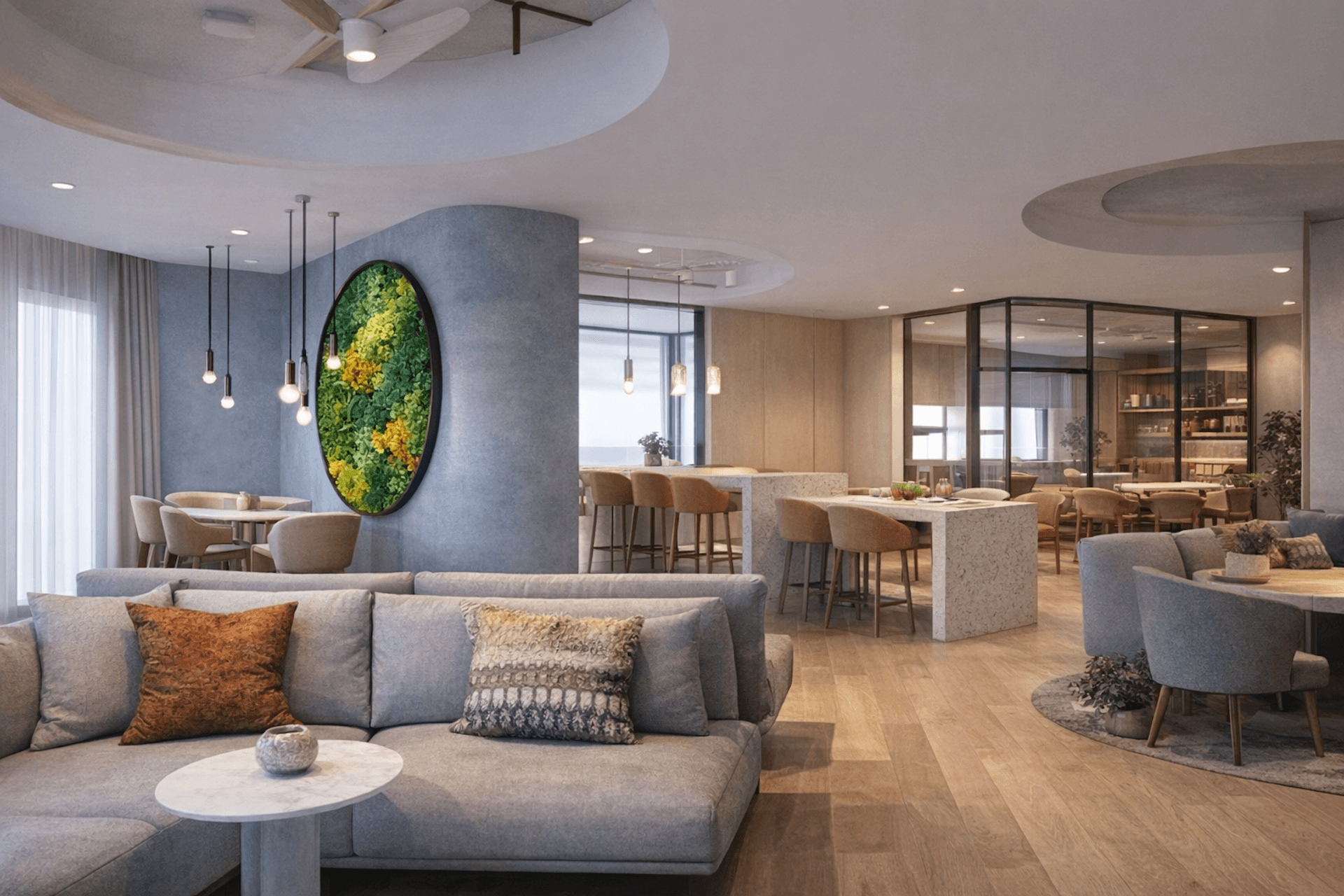 Modern lobby with gray sofa, green plant wall art, pendant lights, and dining area