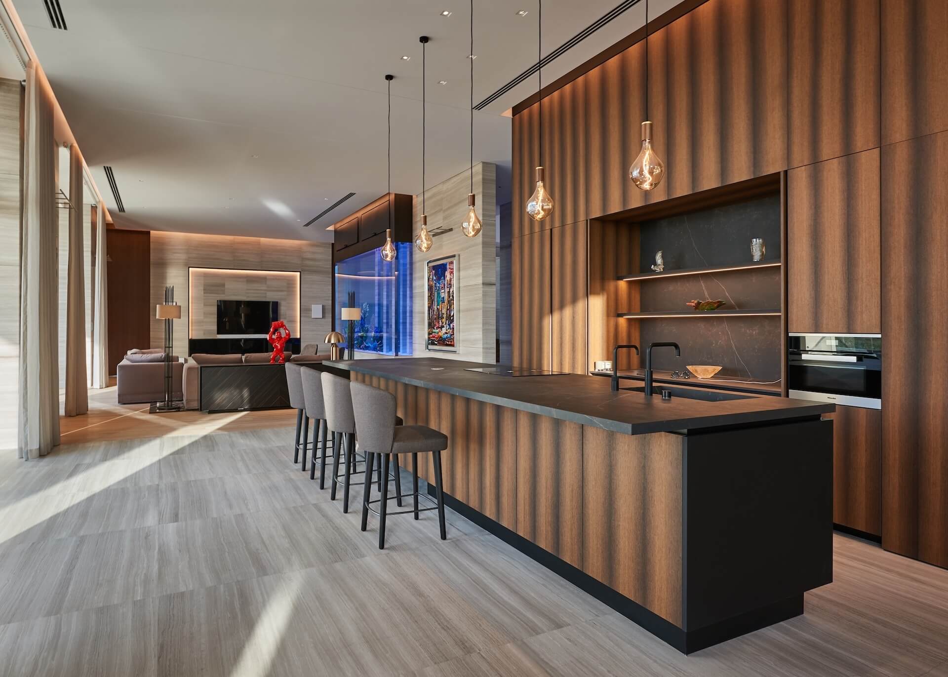 Modern luxury open-plan kitchen and living room with wood paneling and pendant lights