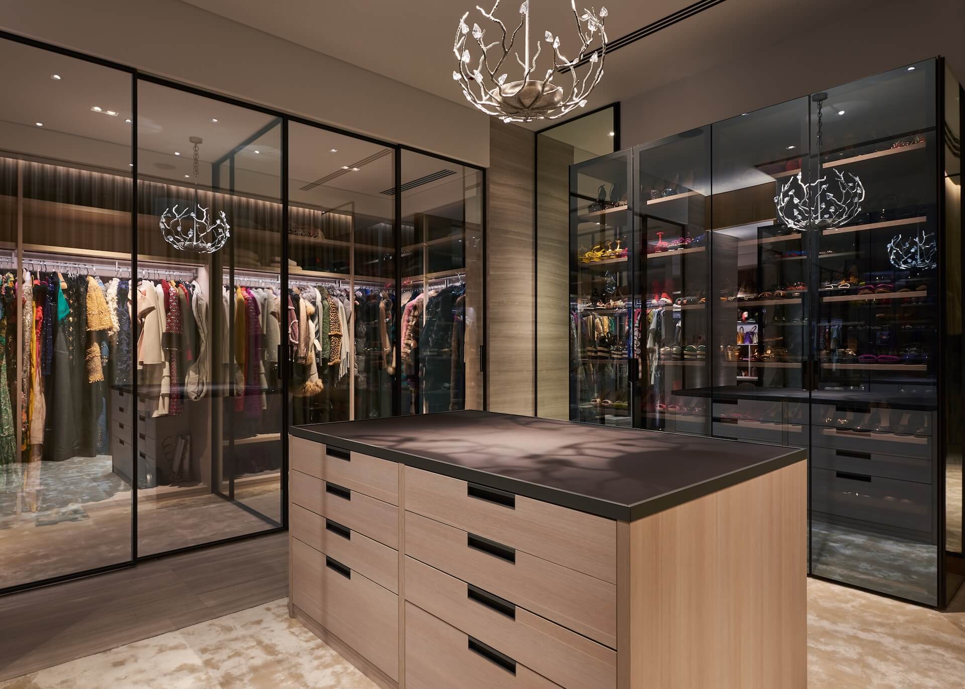Modern luxury boutique interior with glass displays, clothing racks, and decorative branch chandelier