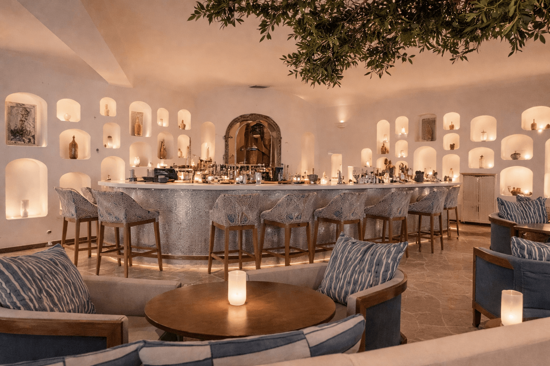 Luxury bar and lounge with curved counter, elegant seating, and illuminated wall niches
