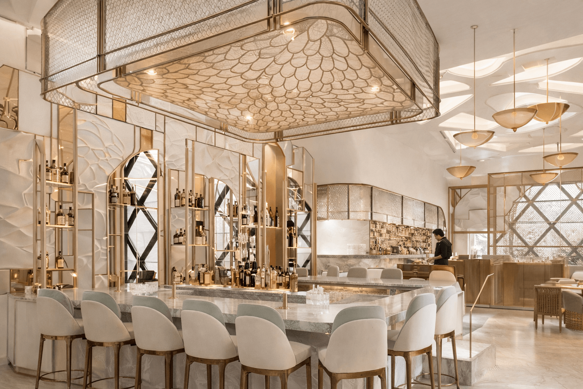 Luxury spa salon with gold fixtures, elegant seating, ornate ceiling, and product displays